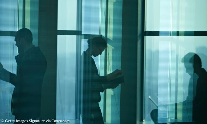 Silhouetten von Männern, die an Computern arbeiten