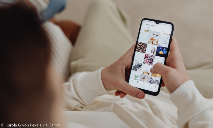 Jemand scrollt auf dem Sofa über Instagram