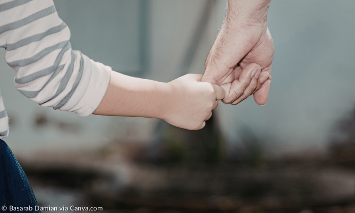 Eine Kinderhand und die Hand eines Erwachsenen