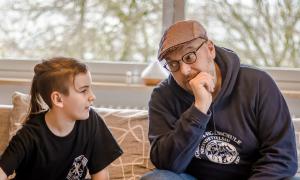 Ein Junge und ein Mann sitzen nebeneinander