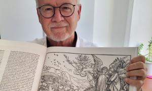 Mann zeigt offenes Buch vor