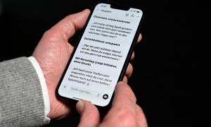 JEmand hält ein Handy in der Hand. Man sieht eine ChatGPT Unterhaltung auf einem Smartphone 