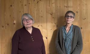 2 Frauen vor einer Holzwand