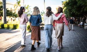 Frauen laufen auf einer Straße und unterhalten sich